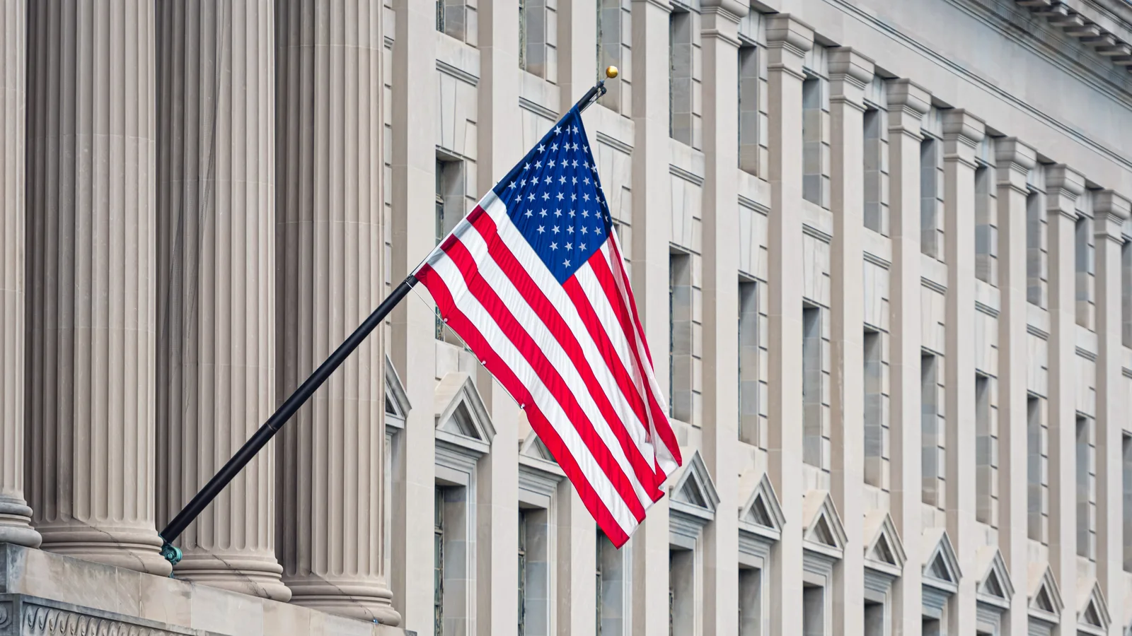 An American flag on the facade of a government building